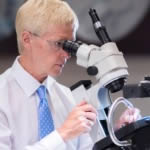 Harold Lindsay examining diamond jewellery under a gemmological microscope