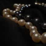 Not all gems sparkle. Shown here is a haematite necklet and a row of Akoya cultured pearls.