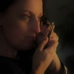 Rachel examining a loose gemstone to asses the quality prior to calculating a value.