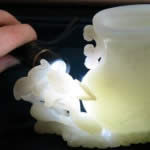 Kehan Li examining a Chinese early Twentieth Century Hetian jade carving