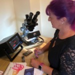 Shirley Mitchell screening a synthetic diamond in an item of jewellery