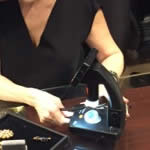 Juanita carrying out a series of tests on a gemstone