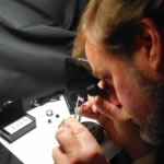 David giving a loose diamond a preliminary examination prior to grading