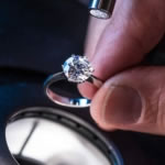 A diamond ring being examined with a microscope under fibre-optic incident lighting