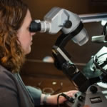 Chaya Udinsky examining a diamond under a gemological microscope.