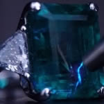 Here, Melissa is using a specialist piece of optical equipment to analyse the filler that this emerald has been treated with to improve the clarity.