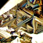 Triangular markings, called trigons, on the surface of a diamond crystal face. These are sometimes visible on cut diamonds where the cutter has left discreet areas unpolished to maintain weight.