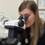 Stephanie using a gemological microscope.
